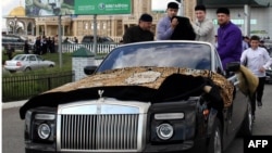 Chechen leader Ramzan Kadyrov (right) escorts the Prophet Muhammad's purported chalice and carpets from the airport to Grozny's central mosque in September.