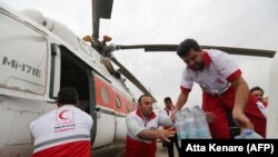 Iranian Red Crescent volunteers receive aid to be distributed to people in Ahvaz, the capital of the southwestern Iranian province of Khuzestan, on April 9.