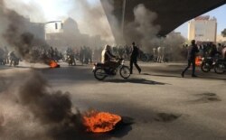 Iranian protesters rally amid burning tires, in the central city of Isfahan on November 16, 2019