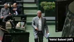 Iranian Labor Minister Ali Rabiei walks to the podium during his parliament impeachment hearing, in Tehran, March 13, 2018