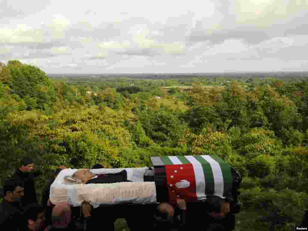 Pall bearers carry the open coffin of Abkhaz leader Sergei Bagapsh to his funeral in the village of Dzhgiarda on June 2.Photo by Sergei Karpov for Reuters