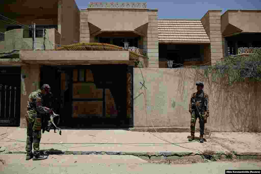 Iraqi soldiers outside the villa used as a prison by Islamic State militants. The incognito prison is an example of the extremist group's new tactic of hiding their operations among the civilian population.
