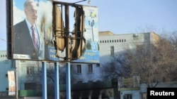 A billboard featuring President Nursultan Nazarbaev was damaged during the violence in the town of Zhanaozen.