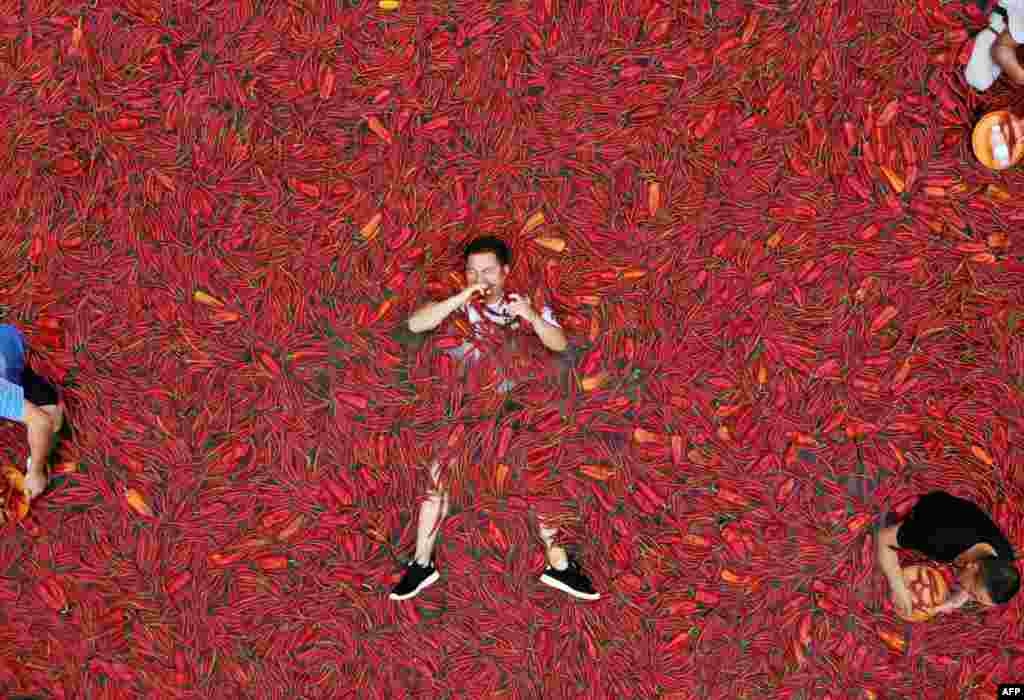A contestant takes part in a chili-pepper-eating competition in China&#39;s central Hunan Province. (AFP)