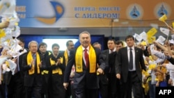 Supporters welcome Kazakh President Nursultan Nazarbaev as he arrives for a celebration rally at a sports center in Astana on April 4.