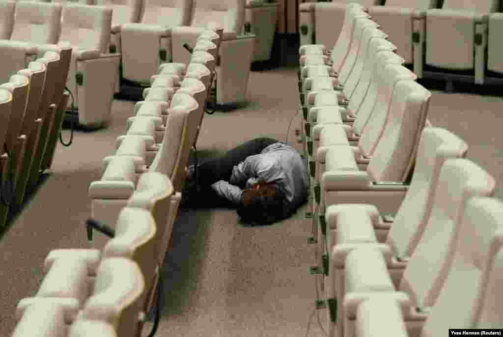 A journalist sleeps while waiting for the end of a European Union leaders summit intended to select candidates for top EU institution jobs in Brussels on July 1. (Reuters/Yves Herman)