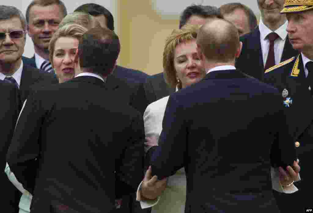 Russian President Vladimir Putin (right) kisses his wife, Lyudmila, as former President Dmitry Medvedev kisses his wife, Svetlana, during Putin&#39;s inauguration ceremony on Sobornaya Square at the Kremlin on May 7. Putin took the oath of office to become Russia&#39;s president for a historic third term. (AFP/Alexander Zemlianichenko)