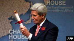 U.K. -- US Secretary of State John Kerry holds a scroll after receiving the Chatham House Prize to recognise his role in negotiating the nuclear deal between Iran and the P5+1 nations at Chatham House in London, October 31, 2016