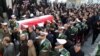 The honor guard carry the coffin of Iran's former ambassador to Lebanon Ghazanfar Roknabadi, who was killed in Saudi Arabia, during a repatriation ceremony upon the arrival of his body at Tehran's Mehrabad Airport on November 27, 2015. 