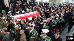 An Iranian honor guard carries the coffin of a former ambassador to Lebanon, Ghazanfar Roknabadi, who was killed during the hajj in Saudi Arabia in a repatriation ceremony upon the arrival of his body at Tehran's Mehrabad Airport on November 27, 2015. 