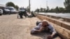 People and soldiers lying on the ground for cover at the scene of an attack on a military parade in the southwestern Iranian city of Ahvaz.