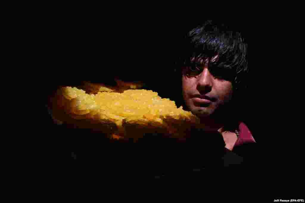 A vendor sells sweets as time to break the Ramadan fast approaches in the western Afghan city of Herat on May 6. (epa-EFE/Jalil Rezayee)