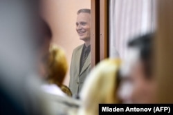 Christensen stands inside the defendants' cage as he awaits the verdict.