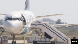 Cyprus - A person believed to be the hijacker leaves the hijacked EgyptAir A320 plane parked at a sealed off area of the Larnaca Airport, in Larnaca, Cyprus, 29 March 2016