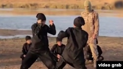 A screengrab from a video purportedly showing young Uyghurs training somewhere in the Middle East and making threats against China. There seems to have been a crackdown on ethnic Uyghurs living in China since the film was released online. 