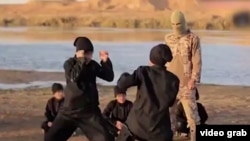 A screengrab from a video purportedly showing Uyghurs training somewhere in the Middle East and making threats against China. 