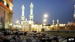 Muslim pilgrims perform the evening prayer near the Grand Mosque in the Saudi holy city of Mecca on November 12.