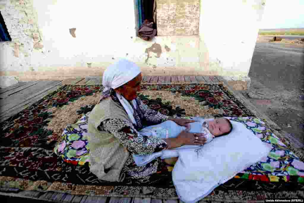 Zhanar&rsquo;s mother-in-law lulls her grandson to sleep.