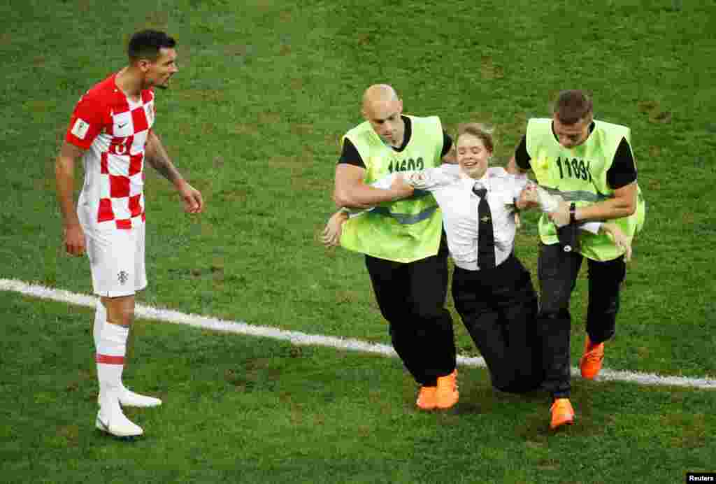 It's unclear how the four were able to make it past the wall of stewards that lined the edge of the pitch. 
