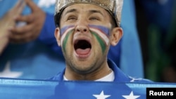 Qatar -- An Uzbek fan shouts before their 2011 Asian Cup semi-final soccer match against Australia at Khalifa stadium in Doha, 25Jan2011