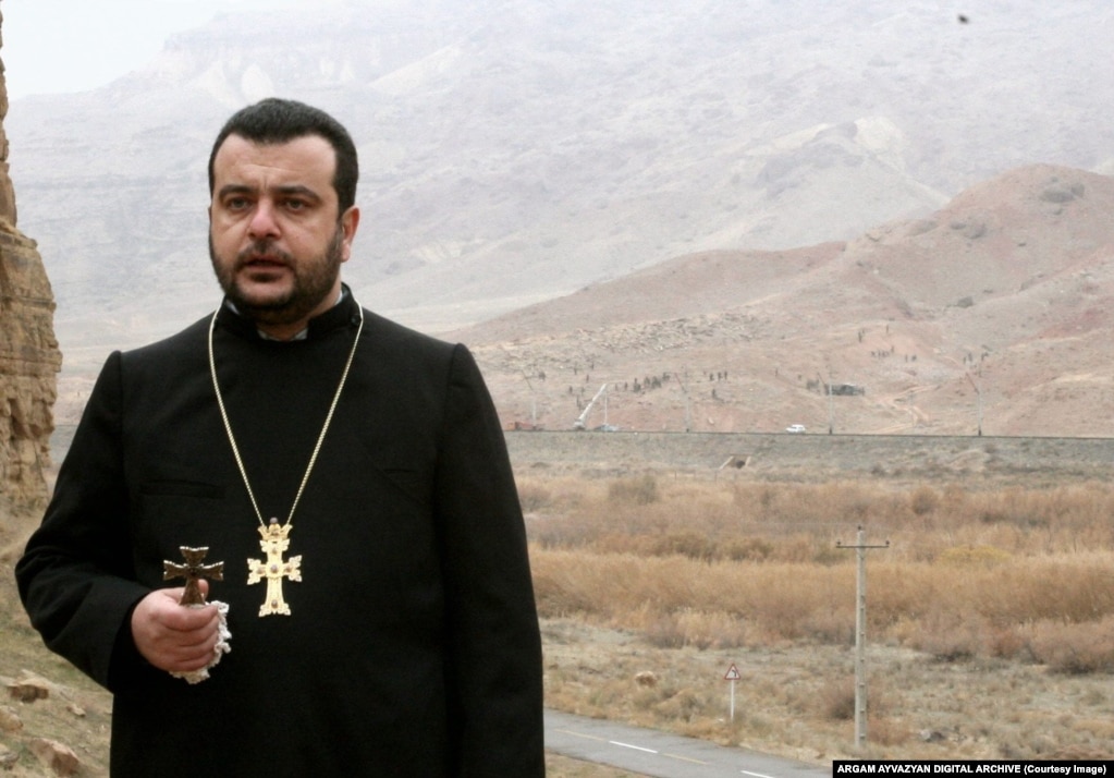 Bishop Topouzian offers a tearful requiem from Iranian soil as the destruction of the Julfa cemetery takes place in Azerbaijani territory in the background. The bishop died in 2010.