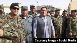 Helmand's security chief Abdul Jabar Qahraman (C) surrounded by police and army officers.