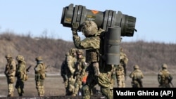 A Ukrainian serviceman carries an anti-tank weapon during an exercise in the Donetsk region this week. 