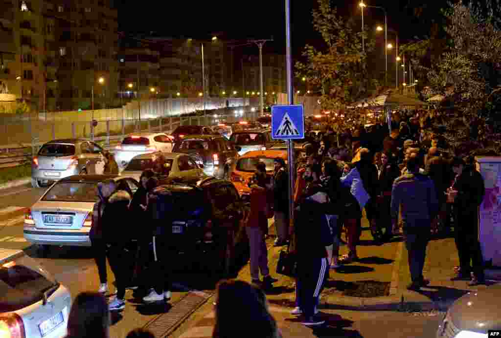 Residents gather outdoors in Tirana, home to nearly 900,000 people, after the first quake hit at around 3:50 a.m. Dozens of aftershocks followed.