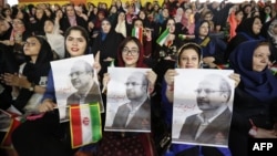 Supporters of Qalibaf, then running for president, hold his portrait during a campaign rally in Tehran in May 2017.