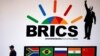 A police officer walks past a billboard outside the BRICS summit meeting in Johannesburg, South Africa, on July 25. 