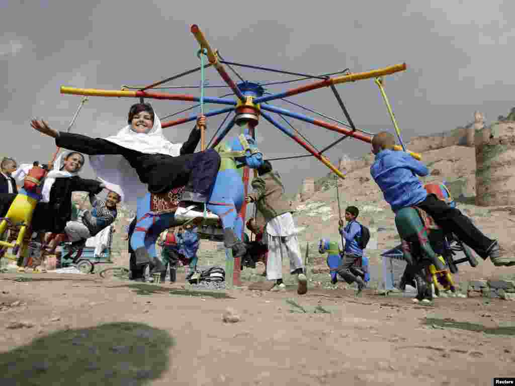 Afghan children play on a makeshift carousel on a street in Kabul on March 29. Photo by Omar Sobhani for Reuters
