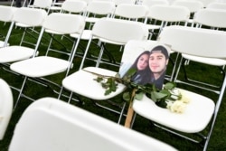 A picture of victims of the MH17 crash rests on empty chairs during a protest outside the Russian Embassy in The Hague on March 8.