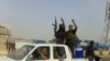 A screen grab taken from a video uploaded to YouTube on June 17 allegedly shows militants ISIL parading with their weapons in the northern Iraqi city of Baiji. 