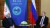 Iranian President Hassan Rouhani (L) meets with Russian President Vladimir Putin on the sidelines of the Shanghai Cooperation Organisation Summit (SCO) in Qingdao, China June 9, 2018. Mikhail Klimentyev/Kremlin REUTERS 