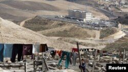 A Palestinian girl stands in an area near Jerusalem known as E1, where there are plans by Israel for the construction of some 3,000 settlers' homes.