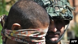 A Pakistani army slodier escorts a suspected Taliban militant in May