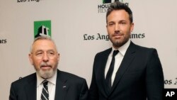 The director and star of Argo, Ben Affleck (right), poses with former CIA agent Tony Mendez in 2012