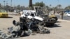 Destroyed vehicles at the site of a car bomb set off by a suicide attacker in the center of Baghdad as part of a wave of deadly attacks across Iraq. 