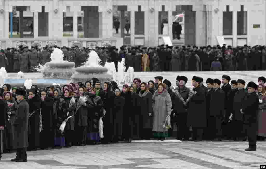 Mourners for Saparmurat Niyazov in Ashgabat (epa) - "State flags are flying at half mast," Drabok continued. "People are wearing hats, even inside, including television news presenters, which signifies mourning. The mourning period will last until December 30. The four national television channels are showing the national flag with a portrait of Niyazov in a black frame, as well as films about his life and condolences from official delegations."