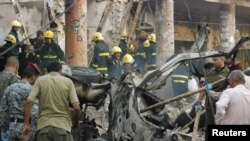 Security personnel and rescue workers gather at the site of a bomb attack in Kut, about 150 kilometers southeast of the Iraqi capital, Baghdad, on August 3.