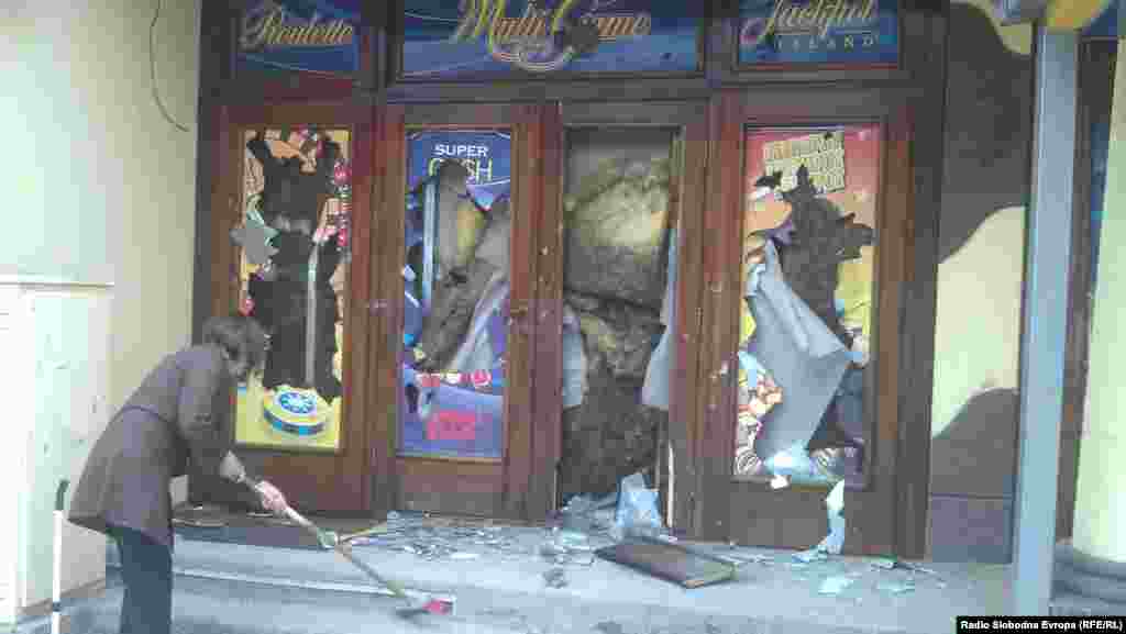 A woman cleans up after the riots on May 19.