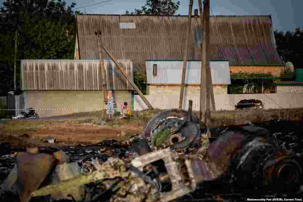 Residents of the village of Grabovo stand near the crash site.