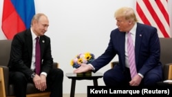 JAPAN -- U.S. President Donald Trump gestures during a bilateral meeting with Russia's President Vladimir Putin at the G20 leaders summit in Osaka, Japan, June 28, 2019.