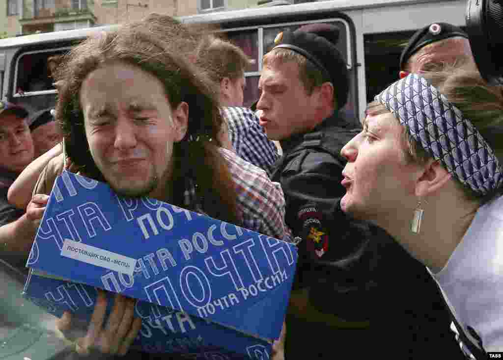 An Orthodox believer spits on a gay-rights activist.