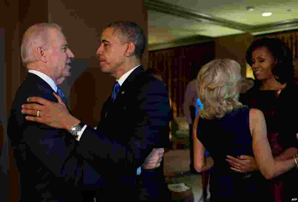 President Barack Obama and First Lady Michelle Obama embrace Vice President Joe Biden and Dr. Jill Biden in Chicago moments after the television networks called the election in their favor.