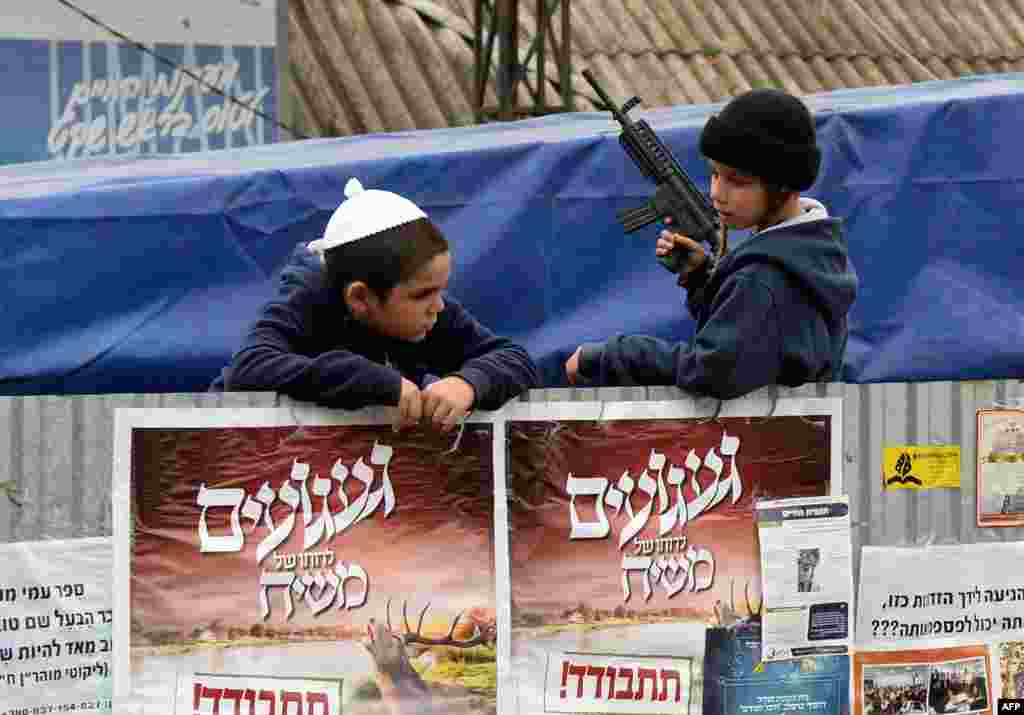 An ultra-Orthodox Jewish boy plays with a toy gun before celebrations for the Jewish New Year in the small Ukrainian city of Uman. Thousands of followers of Rabbi Nachman flocked to Uman from around the world to pay homage to their spiritual leader and celebrate the start of the New Year at his grave. (AFP/Vasily Maximov)