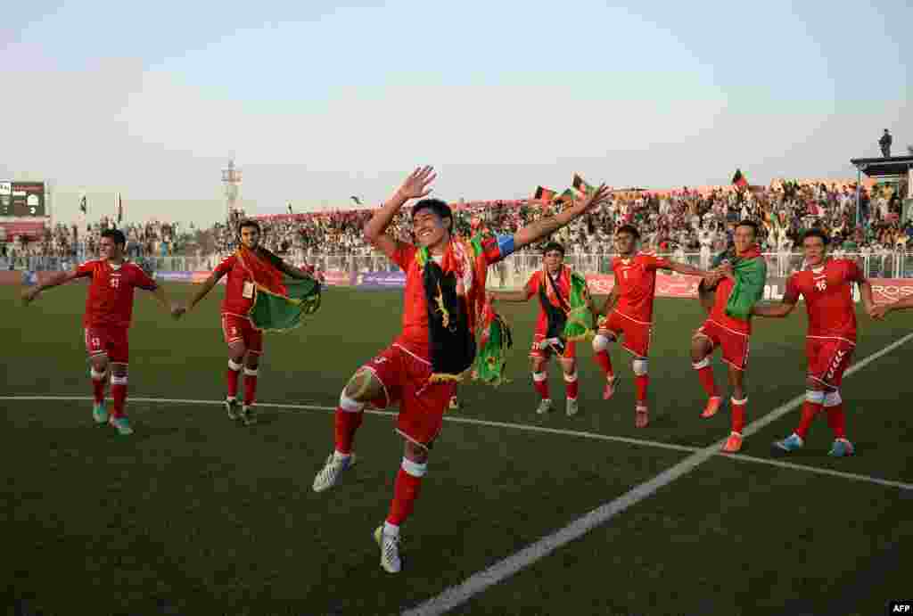Afghan footballers celebrate their 3-0 win in a friendly against Pakistan at the Afghanistan Football Federation (AFF) stadium in Kabul. Afghanistan was hosting its first international soccer match in a decade. Organizers are hoping the FIFA-sanctioned match will ease cross-border tensions between the two neighbors. It&#39;s the first meeting in 36 years for the two nations&#39; national soccer teams. (AFP/Massoud Hossaini)