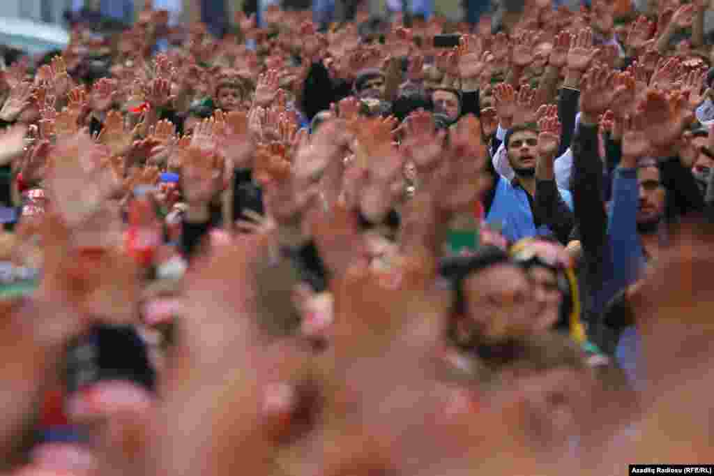 People raise their hands during Ashura celebrations in Baku, Azerbaijan, on September 10.