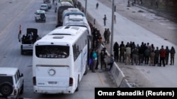 Rebel fighters being evacuated from the city of Harasta in the eastern Damascus suburb of Ghouta, Syria.