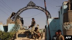 Afghan security forces stand guard at the main gate of the prison, after retaking Kunduz from the Taliban, in Kunduz in October 2015.